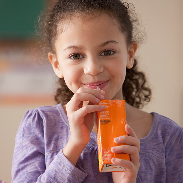 Girl drinking 100% juice box